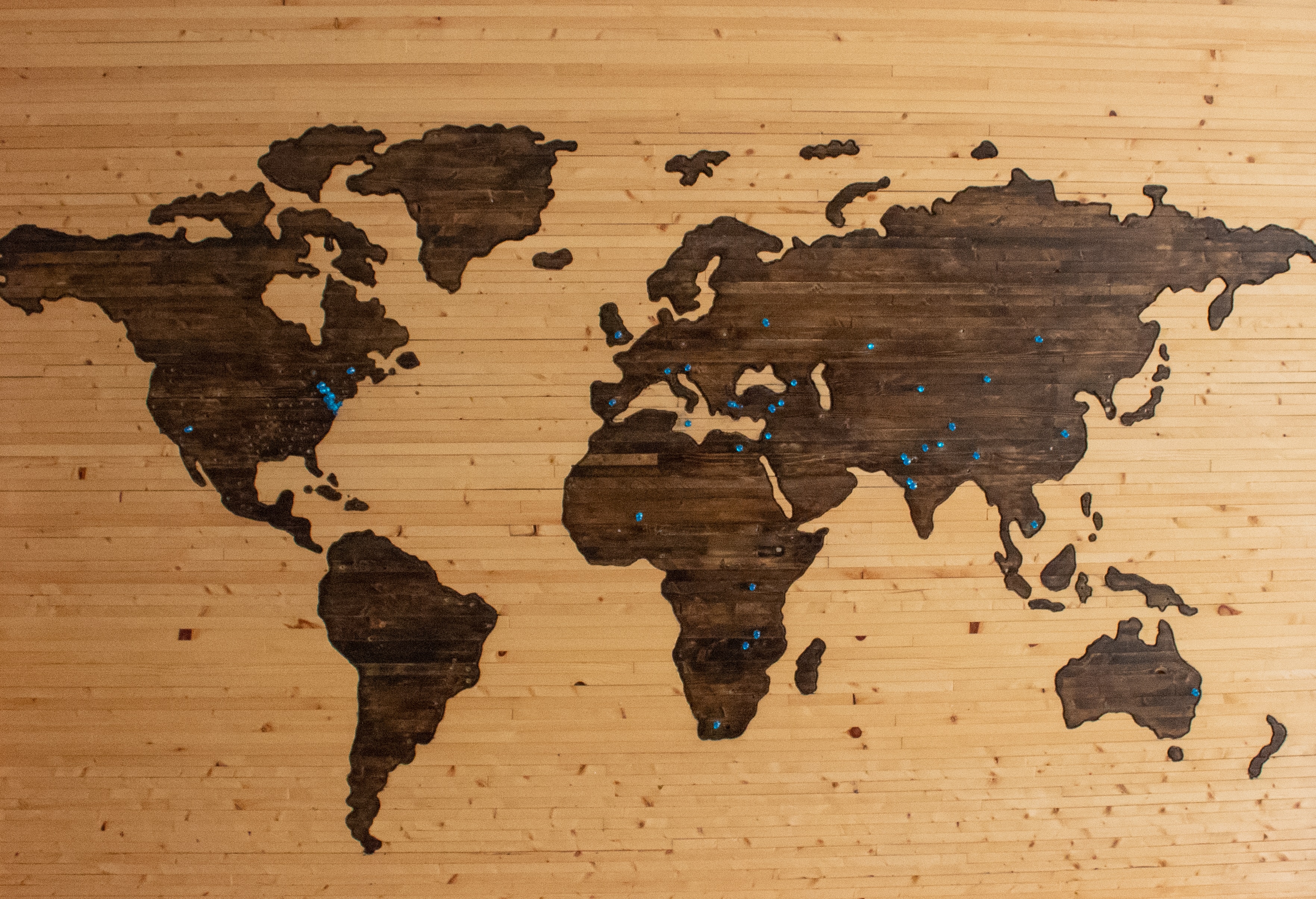 Wood burn world map with blue pins
