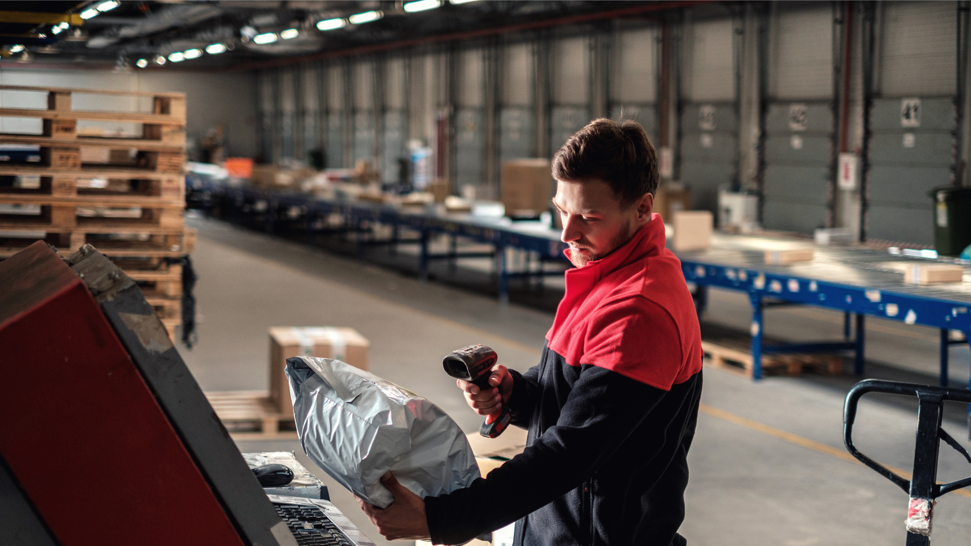 Courier picks up package on a warehouse Indoor Image