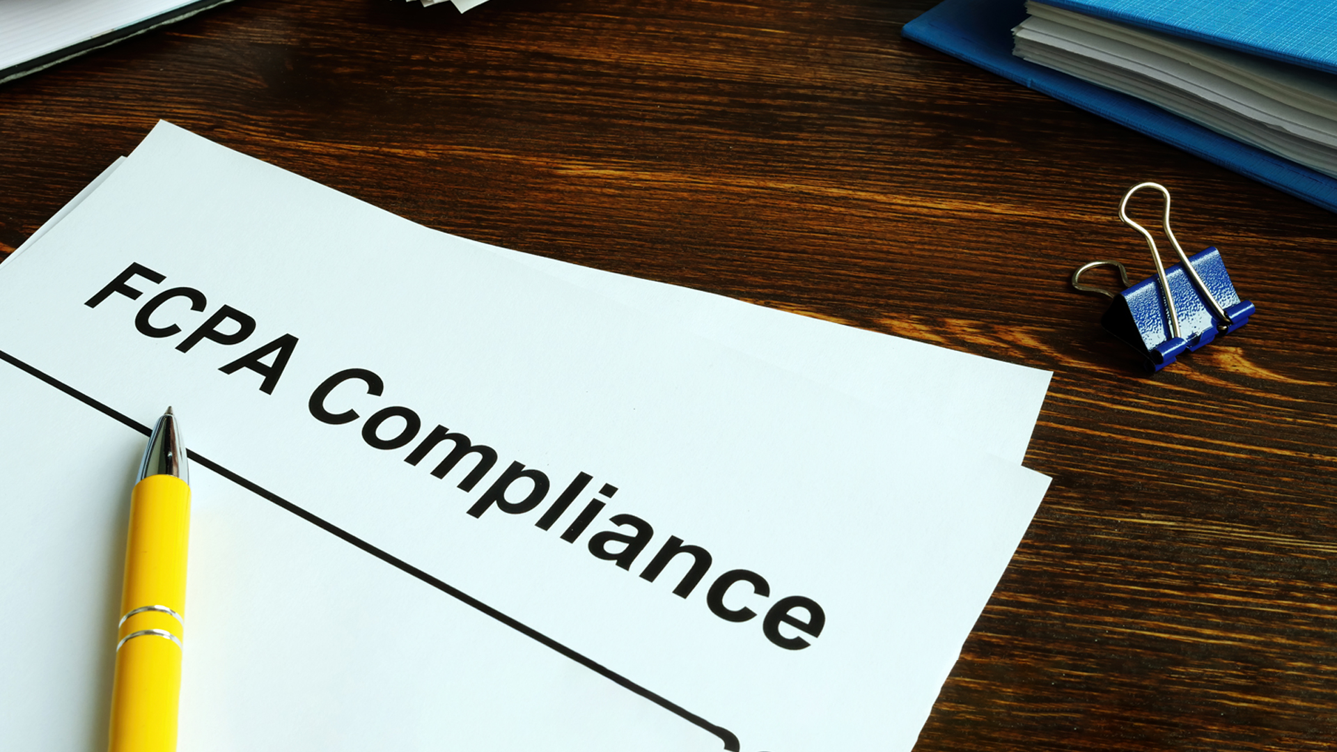 The US Foreign Corrupt Practices Act. FCPA Compliance Guide on the desk image
