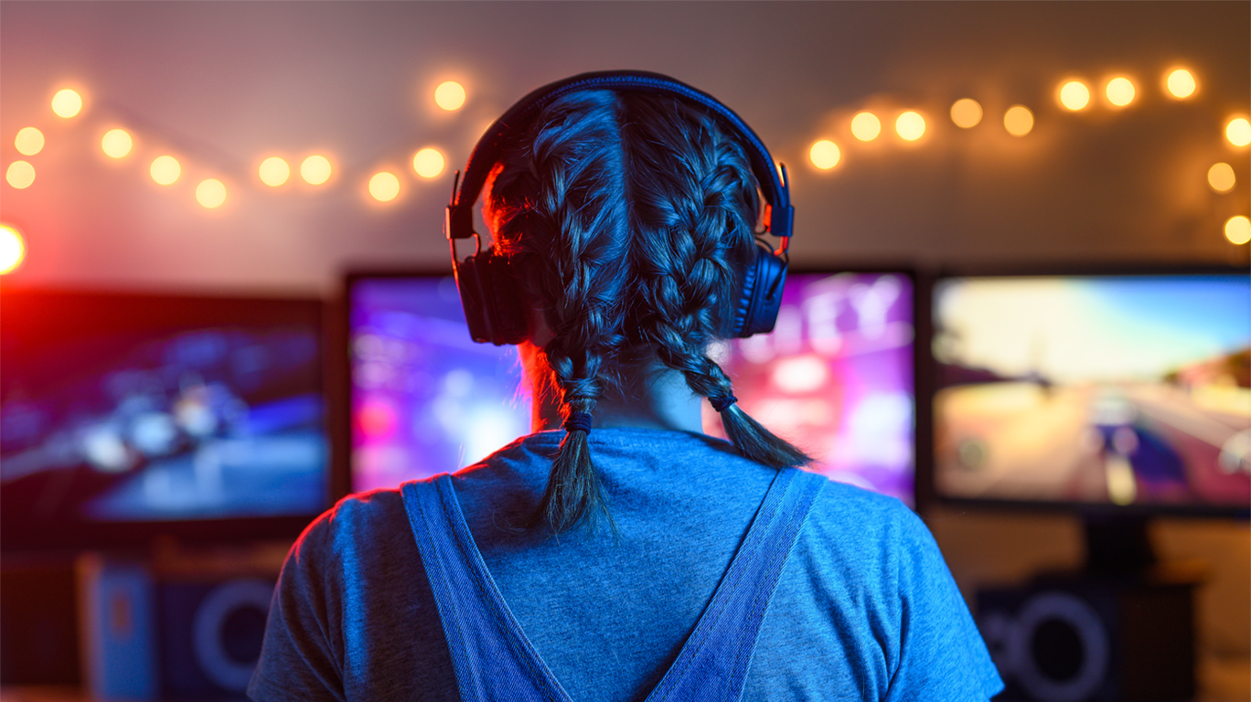 Back of woman with braids playing video games 