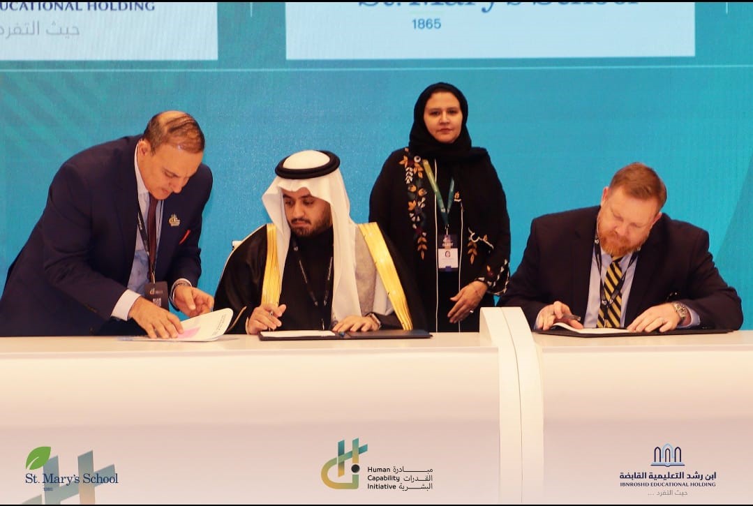 Four people signing an agreement