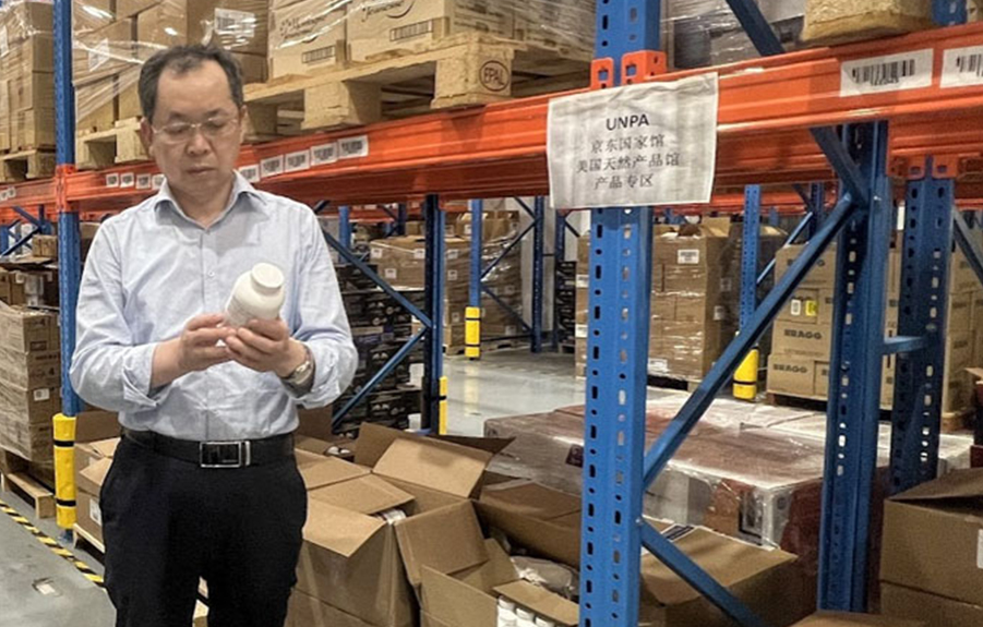 man in warehouse looking at U.S. supplement in China