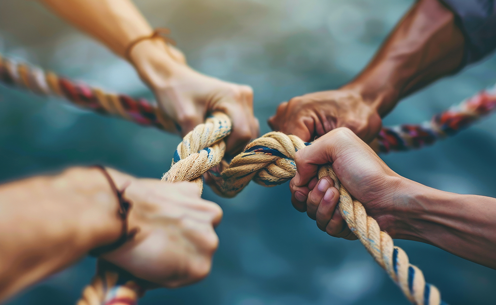 hands holding rope, signifying partnership