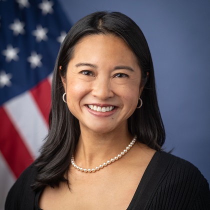 Headshot of Doreen with U.S. flag.