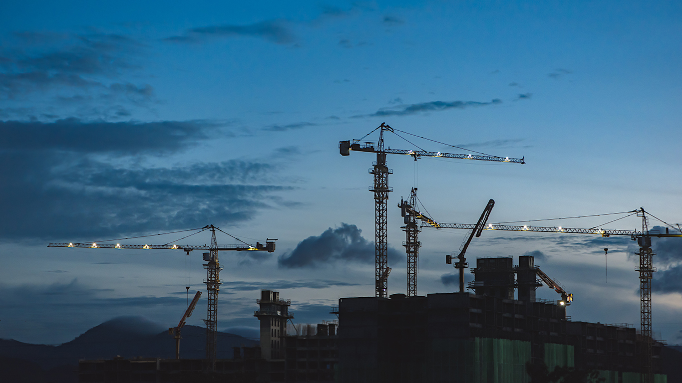 Construction site with cranes at dusk