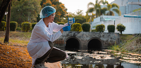 Scientist collects water samples for analysis and research on water quality