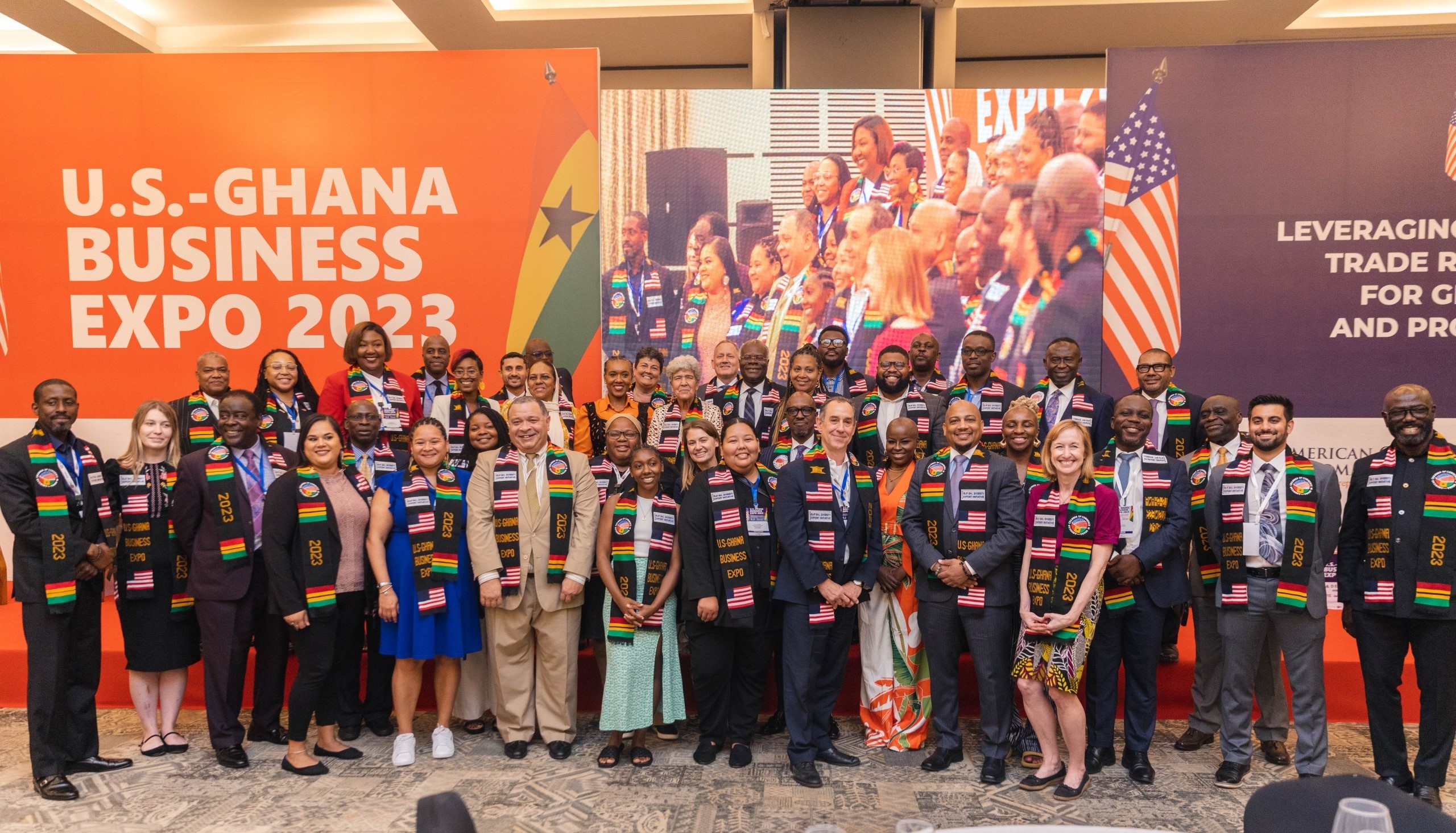 Large group of people in front of U.S. Ghana 2023 Business Expo sign