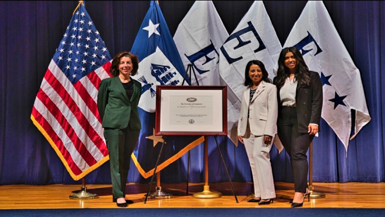 AQMC staff receiving E Award from Secretary of Commerce 