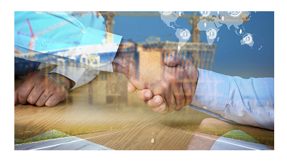 An image of a handshake between two people near an agreement and a world map