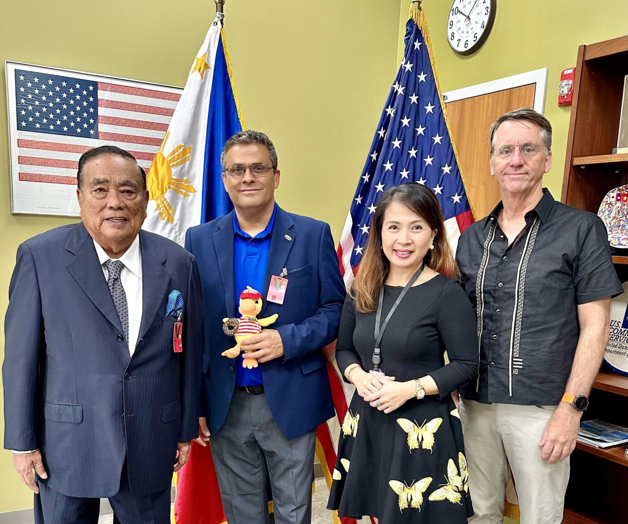 Duck Donuts with CS Philippines Staff and new partner in front of American and Filipino Flags