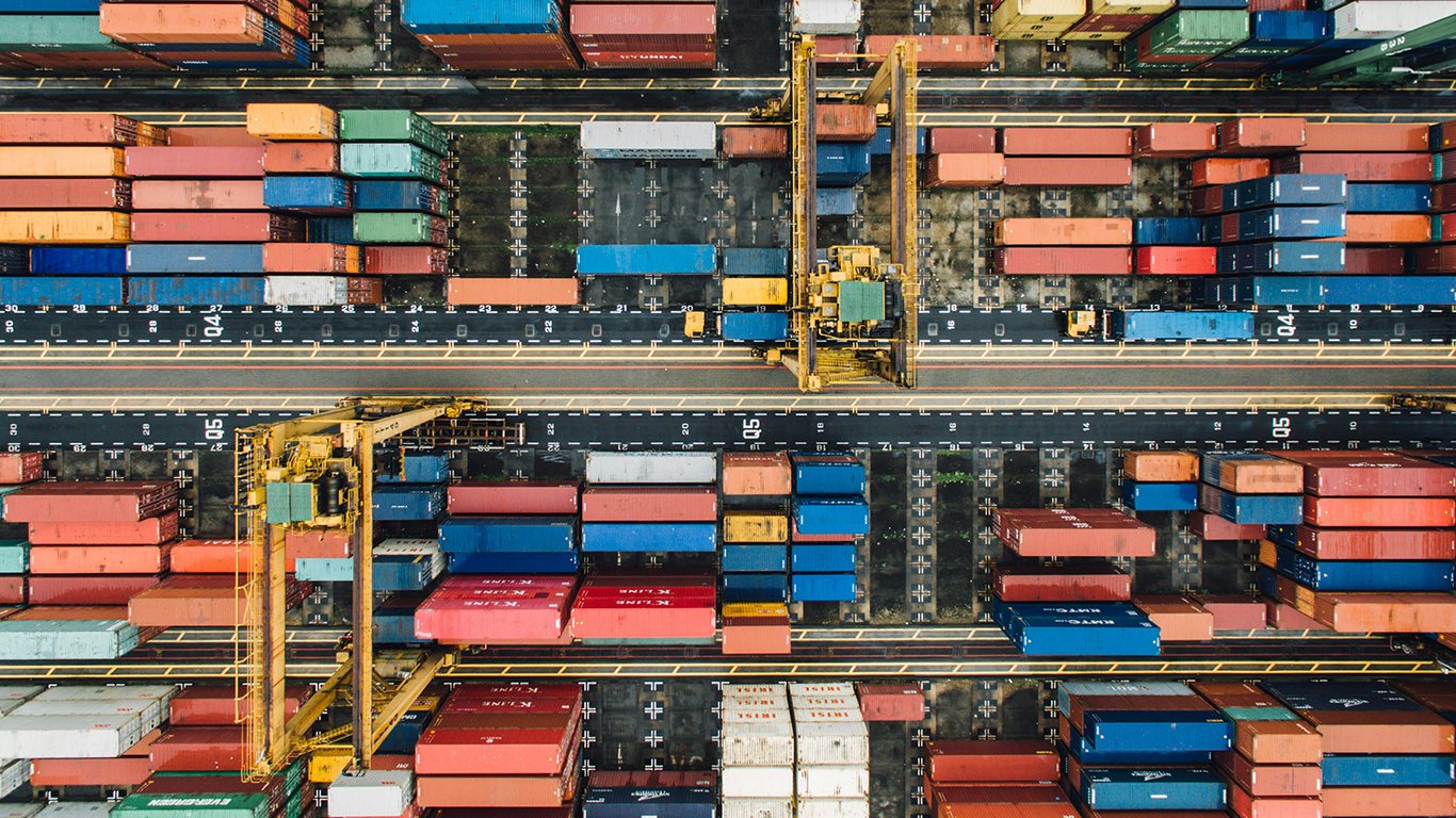 This image shows a top-down view of colorful shipping containers at a port of trade.