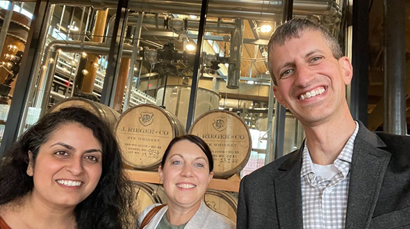 Pinki Thakker, CS/KC L, Emily Gafford, J. Rieger, C, Josh Kaplan, CS/KC, R. take group shot in brewery.