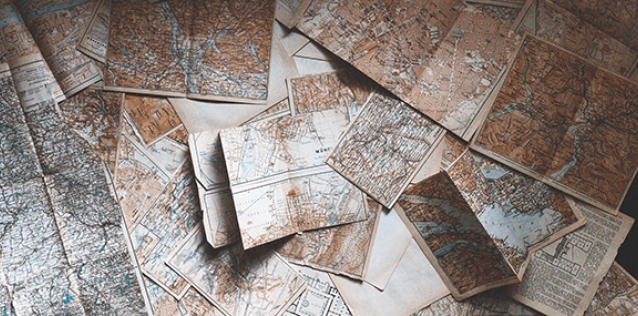 a close up of several scattered maps