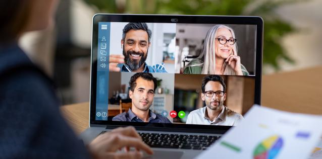 Image of a computer screen with four people meeting virtually