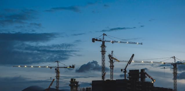 Construction site with cranes at dusk