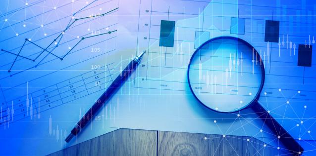 Market Research Line Charts with pen and magnifying glass