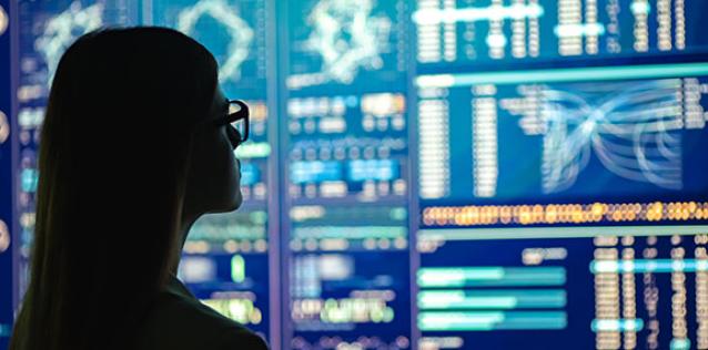 lady looking at charts and graphs on digital wall