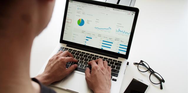 Man looking at website analytics on a laptop