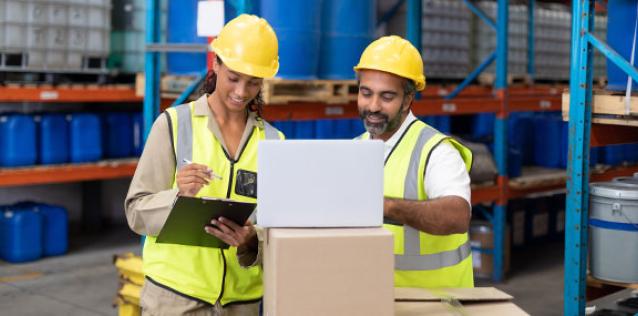 Male and female worker working together in warehouse