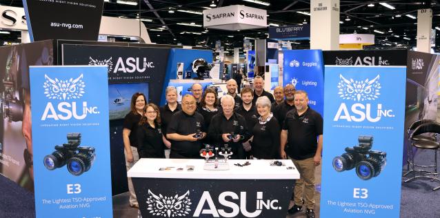 A team of people standing at a trade show booth