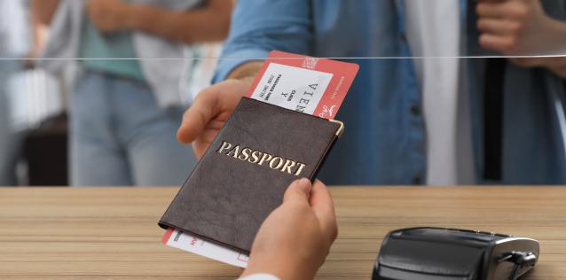 A closeup of a passport exchanging hands