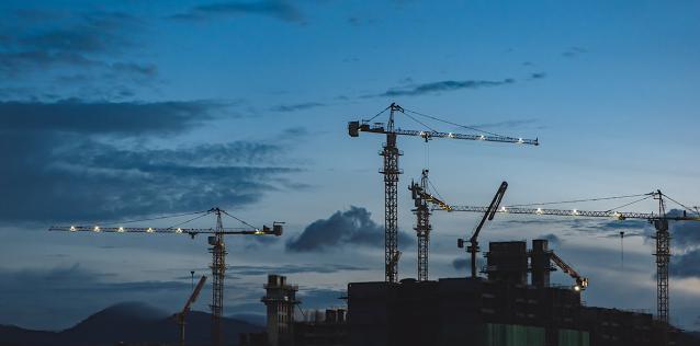 Construction site with cranes at dusk