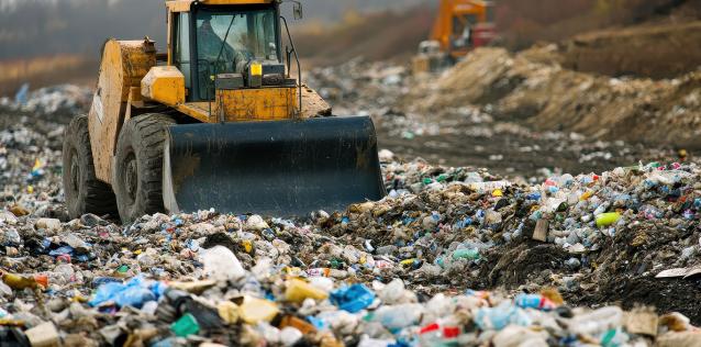 Bulldozer operates in landfill