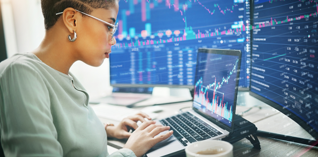 lady working at computer with charts and graphs