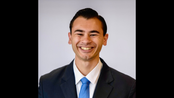 Man in blue tie and black suit