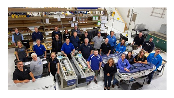 A team standing in front of medical equipment