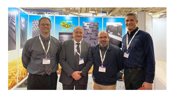 Four businessmen at a trade show booth